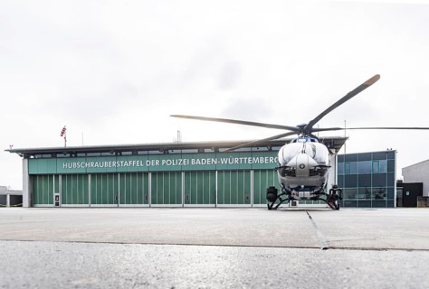 Helicopter from the Baden-WÃ¼rttemberg Police team in front of the hangar at the airport. Airbus