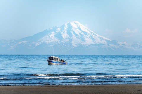 View of Cook Inlet on white mountain peaks of Mount Redoubt, mountains of the Aleutian range, motor