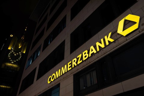 A yellow heart glows on the faÃ§ade of the Commerzbank Tower in Frankfurt am Main at Christmas time