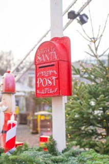 Red mailbox for Santa letters next to Christmas tree at Christmas market, Sindelfingen, Böblingen
