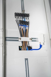 Close-up of a distribution box with several colored cables and connectors, electrician, new