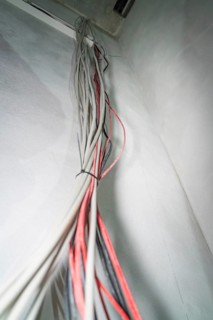 Close-up of cables running side by side along a whitewashed wall, electrician, new building,