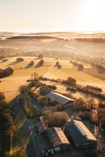 View of a farm and fields in warm morning light, surrounded by trees, Gechingen, hedges and GÃ¤u