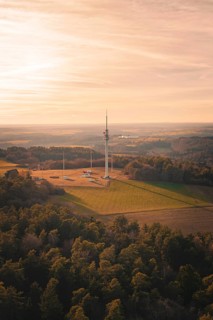 Radio mast overlooking a vast and quiet landscape, in soft evening light, Gechingen, Hecken and