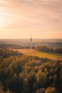 Bird's eye view of radio tower surrounded by thick forests at dusk, Gechingen, Hecken and GÃ¤u