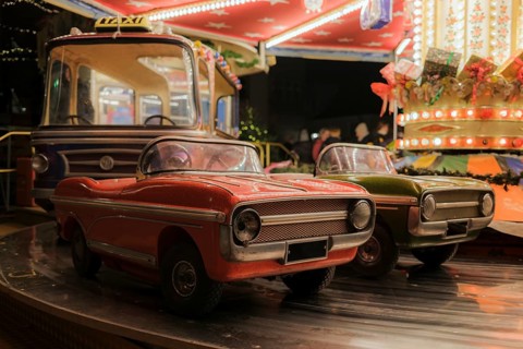 Children's carousel, classic fair ride at a Christmas market, with classic car models, classic