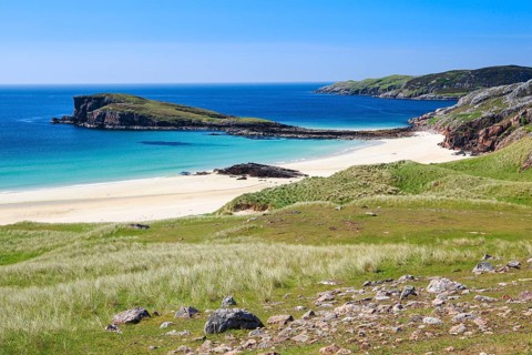 Dunes covered with beach oats line the idyllic sandy beach of Oldshoremore on the west coast of