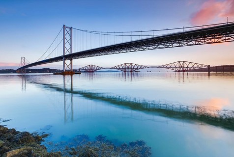 View of the Forth Road Bridge and the red Forth Bridge railway bridge at the FÃ­rth of Forth sea