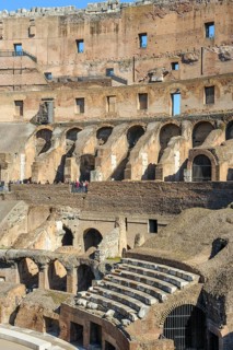 Restored historic grandstand seating marble seats near east entrance to the Colosseum, Rome,