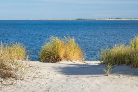 Elbow sand dunes on the coast of the German island of Sylt with a view of the island of RÃ¸mÃ¸ in