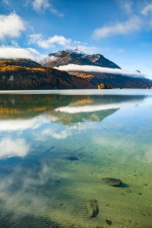 Clouds of fog over Lake Sils with Piz da la Margna in the background, Upper Engadin, Canton of
