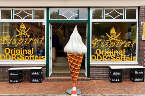 Shop window with inscription original GDR soft ice cream, soft ice cream bag in front of the