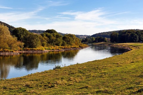 Picturesque landscape with wooded hills and floodplain landscapes, banks of the Weser, river