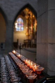 Burning candles in Radolfzell MÃ¼nster, which create a peaceful and spiritual atmosphere,