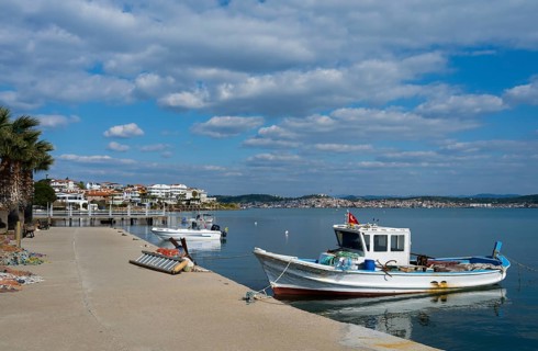 Two fishing boats in calm water near a concrete pier under cloudy sky, Alibey, Alibey Adasi Island,