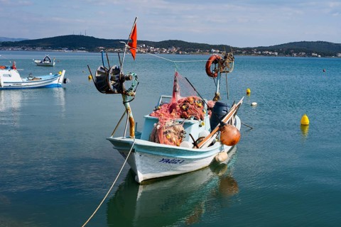 A fishing boat full of nets and equipment floats quietly on the water, Alibey, Alibey AdasÄ±