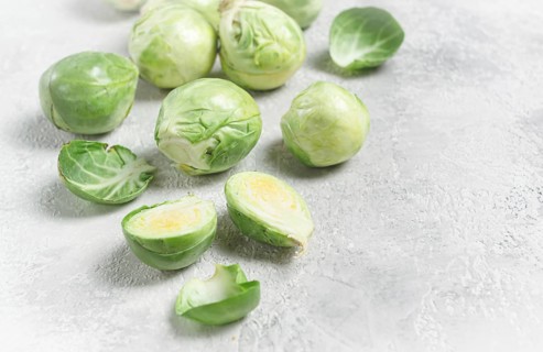 Fresh Brussels sprouts, raw, top view, on a gray table, no people