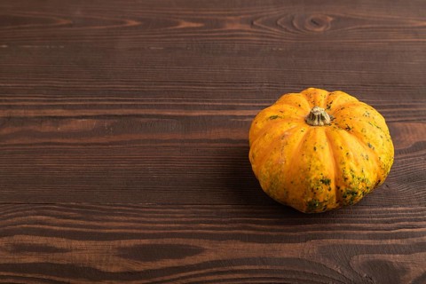 Orange Pumpkin on brown wooden background. Side view, copy space. healthy food, vegetable,