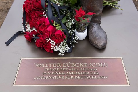 Red roses with a mourning ribbon lie on the Walter LÃ¼bcke memorial during the erection of Walter