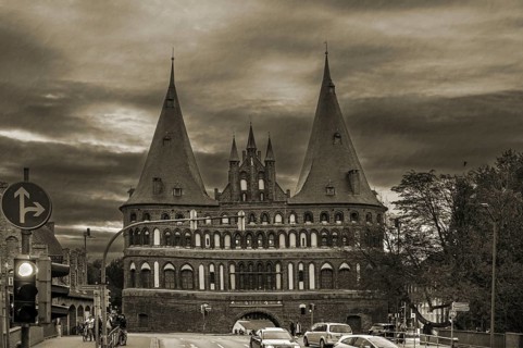 Holstentor, historic city gate from 1478, in the evening, sepia, Holstentorplatz, Hanseatic City of