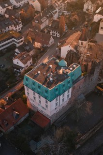 Old building with copper roof in a small village surrounded by autumn trees, Dillweisenstein,