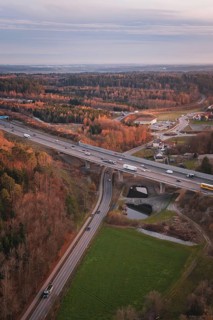 Junction of roads surrounded by forests, at dusk, showing rural transport infrastructure, A8