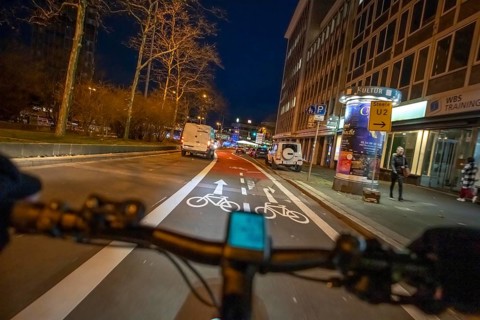 Cycling in the city, in the dark, in the evening, cycling on a bike lane, marked, Huyssenallee,