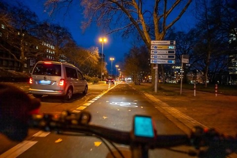 Cycling in the city, in the dark, in the evening, cycling on a bike lane, Huyssenallee, in front of