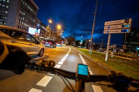 Cycling in the city, in the dark, in the evening, cycling on a bike lane, Huyssenallee, on
