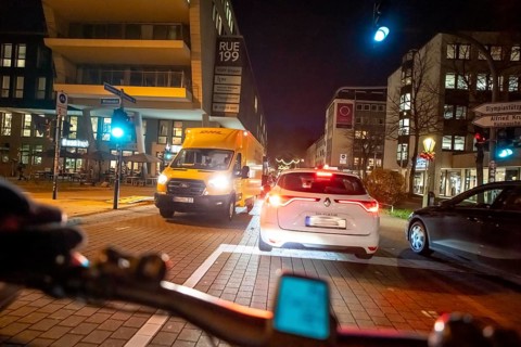 Cycling in the city, in the dark, in the evening, cycling on a bike lane, marked, between 2 lanes,