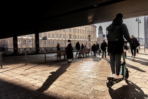 Passers-by on a sidewalk on GrunerstraÃŸe, near Alexander Platz, bus stop, in Berlin, shade, low