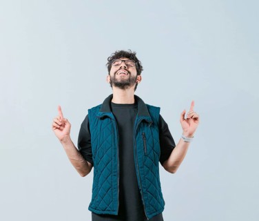 Handsome man in glasses pointing an advertising up isolated. Young man pointing blank space up and