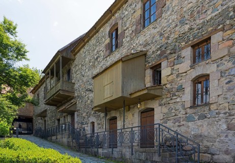 Stone building with many windows and historic charm, surrounded by nature, Old Town, Sharambeyan