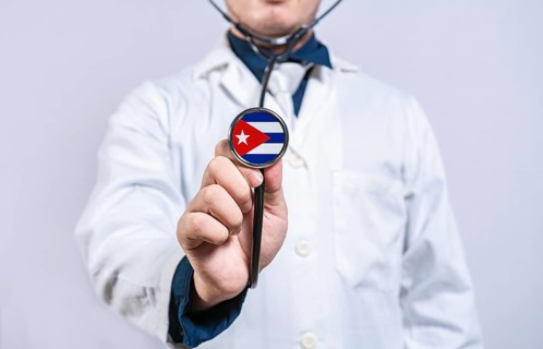 Healthcare worker holding stethoscope with Cuba flag. Cuba health and care concept