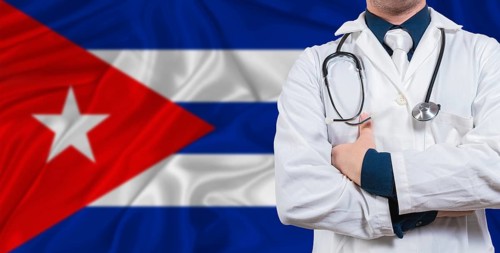 Male doctor with stethoscope on Cuba flag. Doctor holding stethoscope on Cuba flag