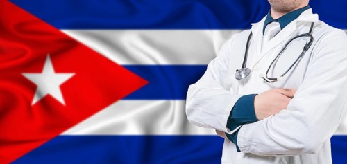 Cuba healthcare concept. Male doctor on Cuban flag. Doctor with crossed arms on Cuba flag