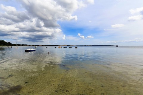 Picturesque coastal landscape with boats on water, sunny summer weather, MÃ¶nchgut, RÃ¼gen, Germany
