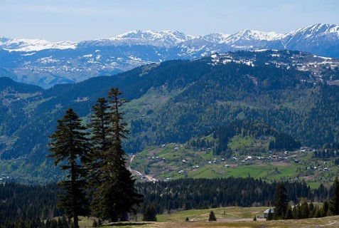 Snow-capped mountains with green valleys and scattered villages, view from Goderdzi Pass, Ajara