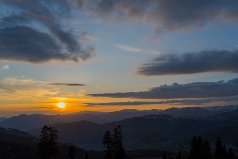A romantic sunset over mountains with colorful sky and clouds, view from Goderdzi Pass, Ajara
