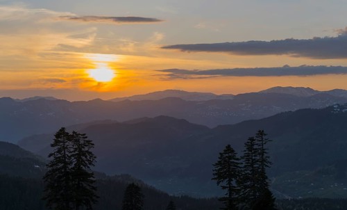 An impressive sunset over a mountainous landscape with a golden sky, view from Goderdzi Pass,