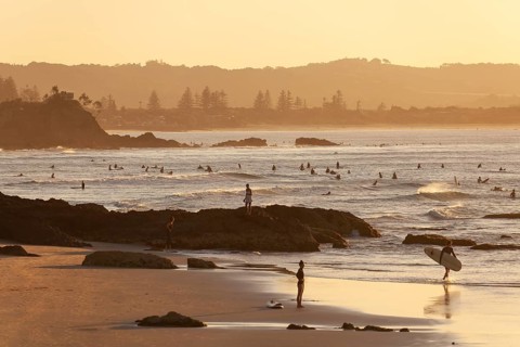 Fisherman Lookout, The Pass and surfers in the evening light of Byron Bay, New South Wales,