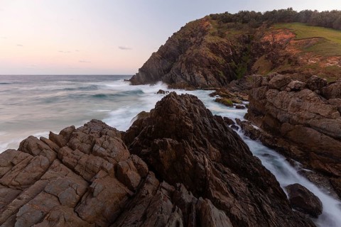 Rocks at the easternmost point of mainland Australia at sunset. Cape Byron near Byron Bay, New