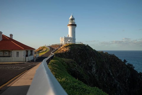 Byron Bay lighthouse on the cape with blue skies and good weather. View from the way to Cape Byron