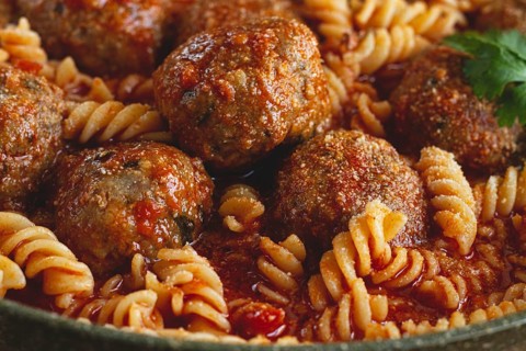 Minced meat meatballs, in tomato sauce, with fusilli pasta, in a cast-iron pan, homemade, no people