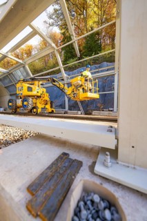 Interior view of a construction site with yellow machines and a metal frame, Hermann Hesse Railway