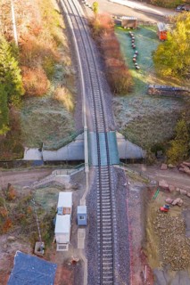 Aerial view of tracks at a railroad crossing with surrounding vegetation, Hermann Hesse Railway bat