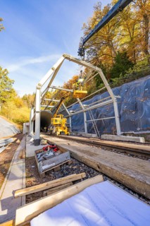 Construction plans and materials on a construction site where workers build metal structures,