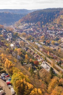Aerial view of a town in an autumn landscape surrounded by hills, Hermann Hesse Railway Bat Tunnel