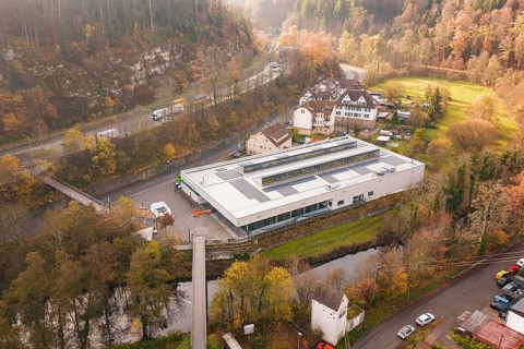 Hilly area with a building with solar systems in a village, PV at Walther Lindner Sporthalle Calw,