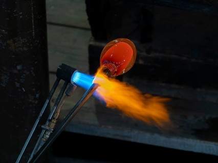 Glassblowers at work, molten glass and flames, Bohemia, Czech Republic